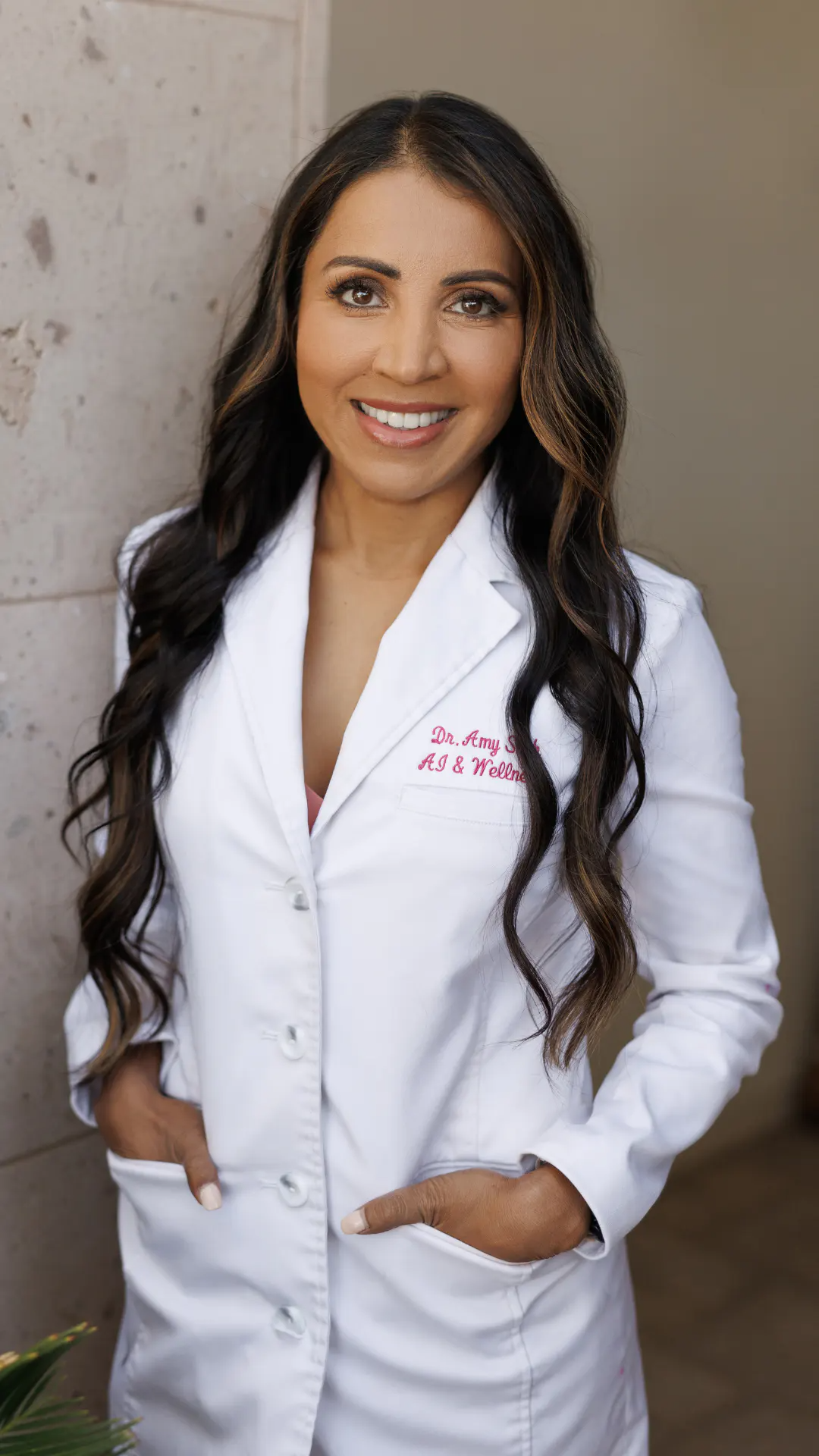 Dr. Shah wearing a white lab coat